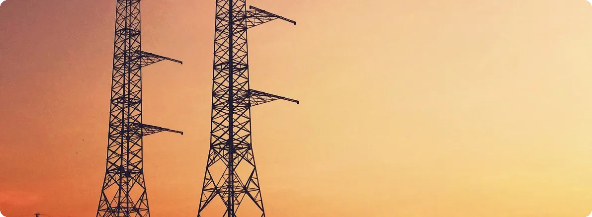 High-voltage power transmission infrastructure at dusk.